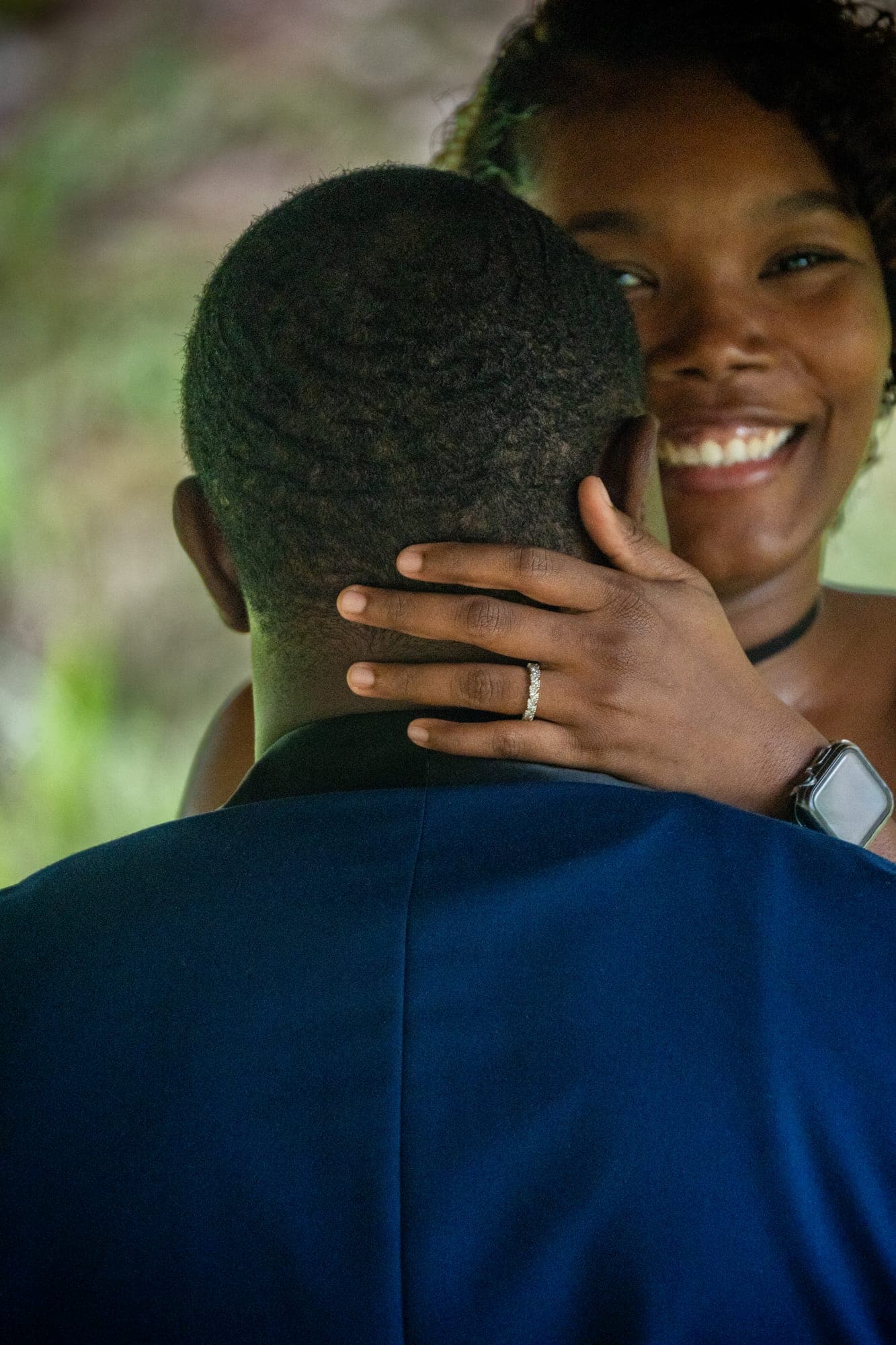 Stevie-Ann smiling over Don's shoulder, her engagement ring on his neck